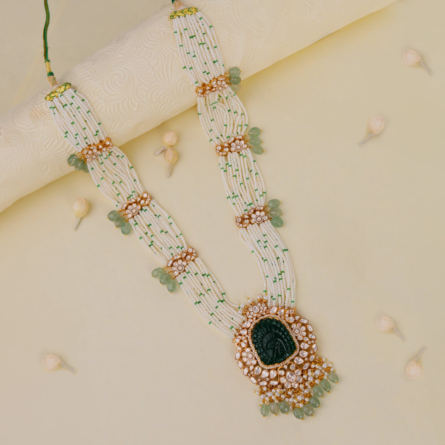 traditional jadau maala with uniquely carved emerald stone in mozanite stones and pearl strings