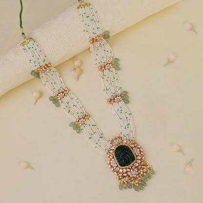 traditional jadau maala with uniquely carved emerald stone in mozanite stones and pearl strings