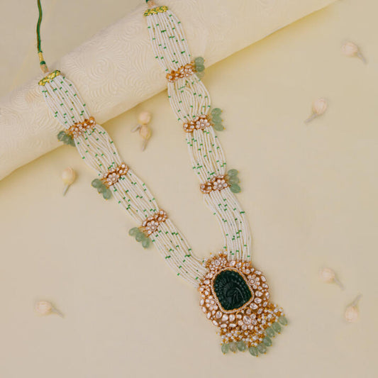 traditional jadau maala with uniquely carved emerald stone in mozanite stones and pearl strings