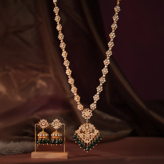 Long floral necklace with pendant design and emerald jhumkis in traditional style