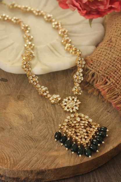 Long floral necklace with pendant design and emerald jhumkis in traditional style