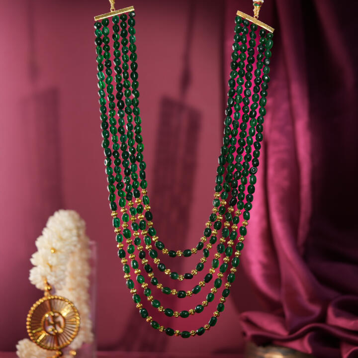 Traditional maala design in emerald and gold beads perfect for a royal Indian wedding