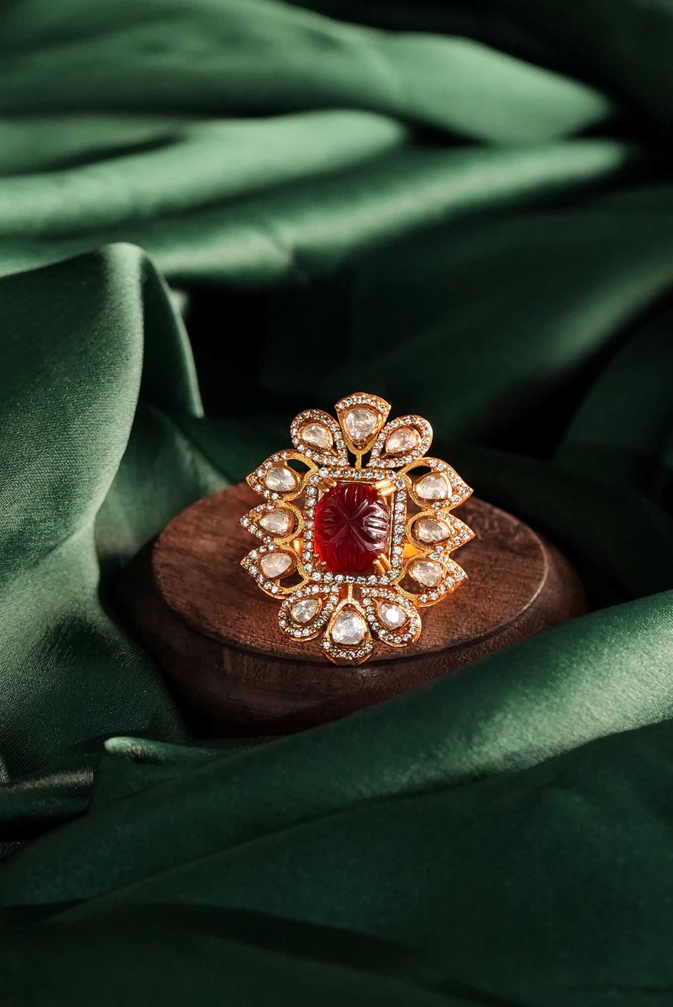 gold Plated ring with a central carved red gemstone