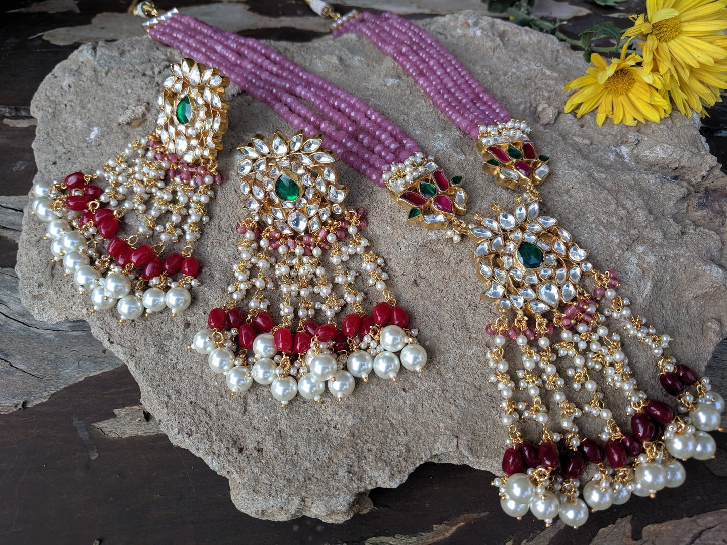 long pink string pendant necklace with green, white and red stones